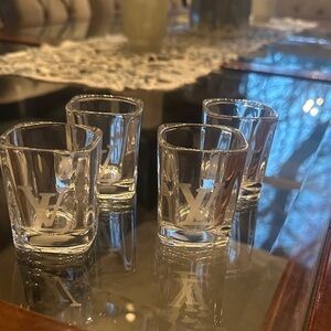 4 never used square crystal shot glasses with LV engraved on each one.